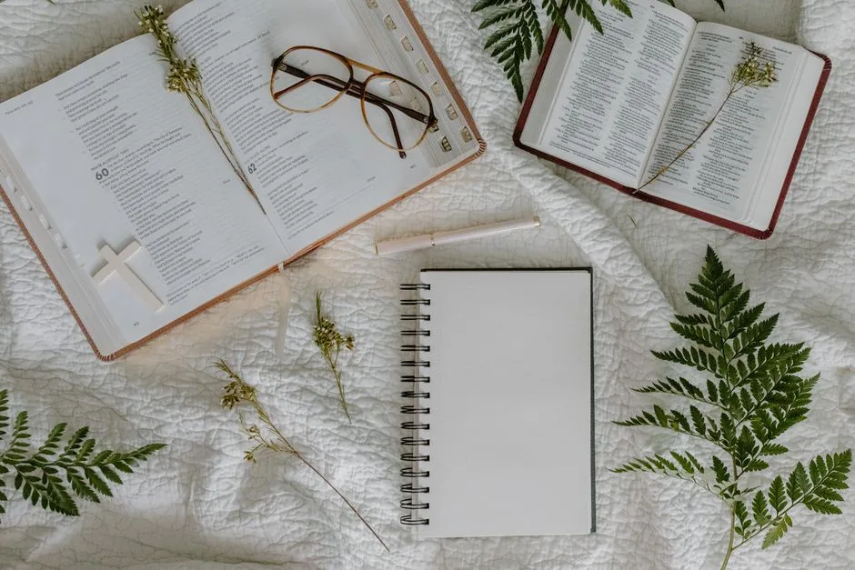 An open Bible beside a pair of headphones on a wooden desk, two ways into the same Word