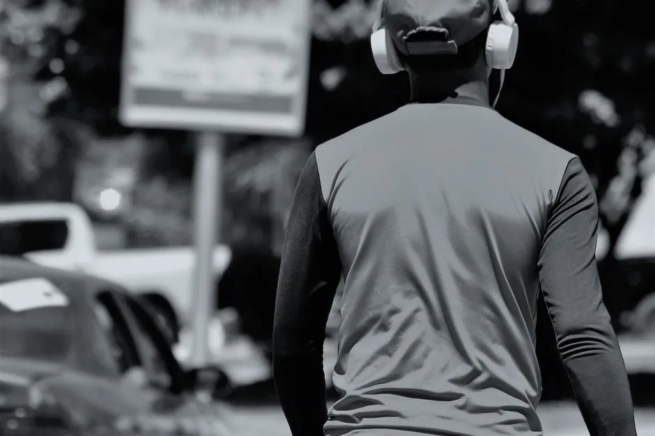 A person walking outdoors with headphones in, working through a year of Scripture one daily episode at a time