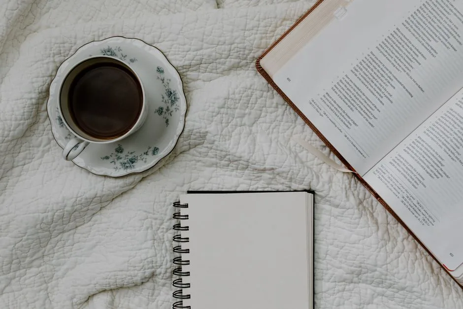 A cozy morning scene with coffee and headphones, the daily ritual of listening through Scripture one cup at a time