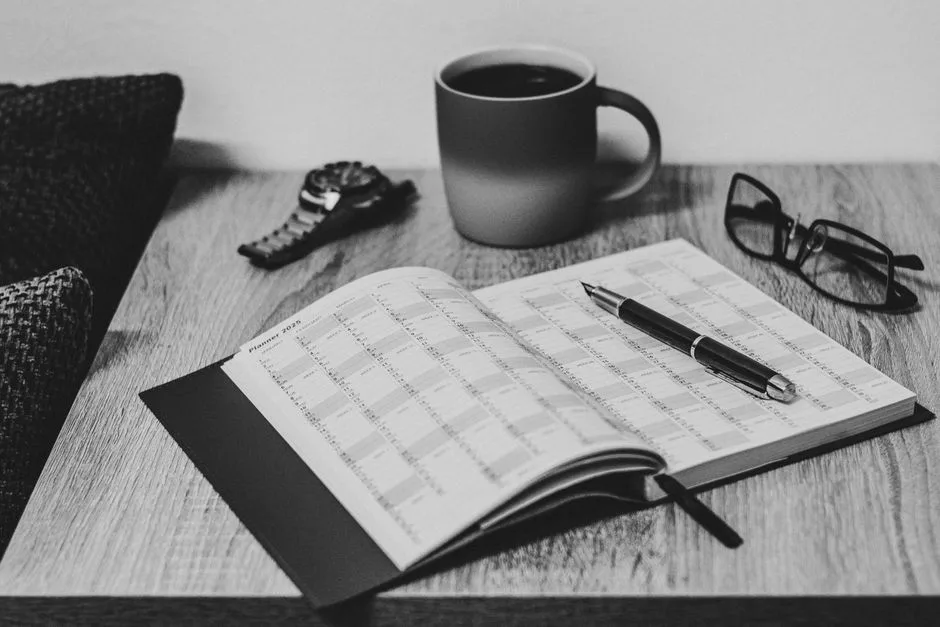 A Bible open on a desk with a 30-day reading tracker beside it, the short-term commitment that builds the long-term habit of Scripture engagement