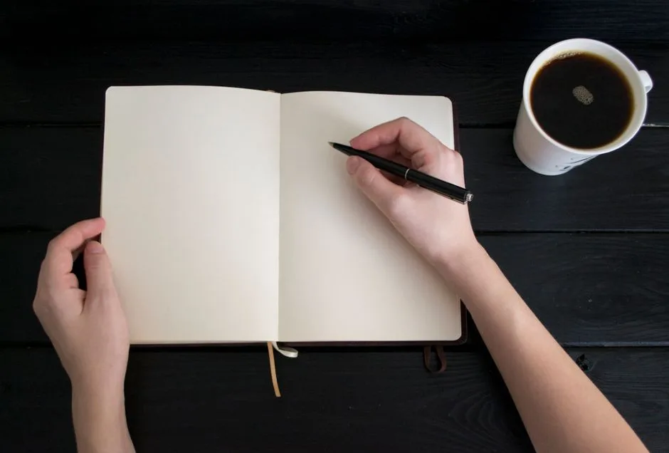 A parent and child sitting together with a journal, building the habit of prayer that will carry through an entire lifetime