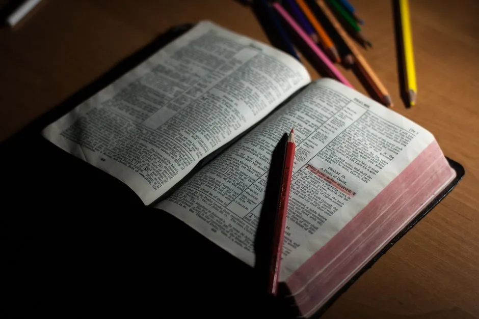 An open Bible on a sunlit desk. Scripture as the foundation for daily growth