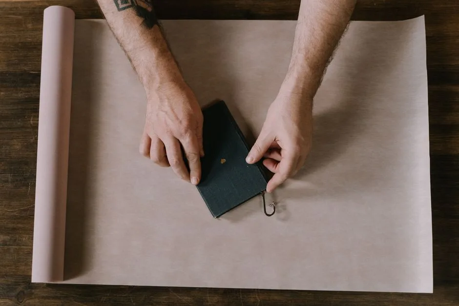 A wrapped gift and a devotional book on a wooden table