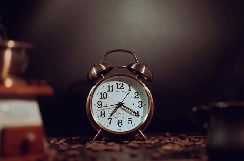 A clock beside an open Bible, making the most of limited time with God