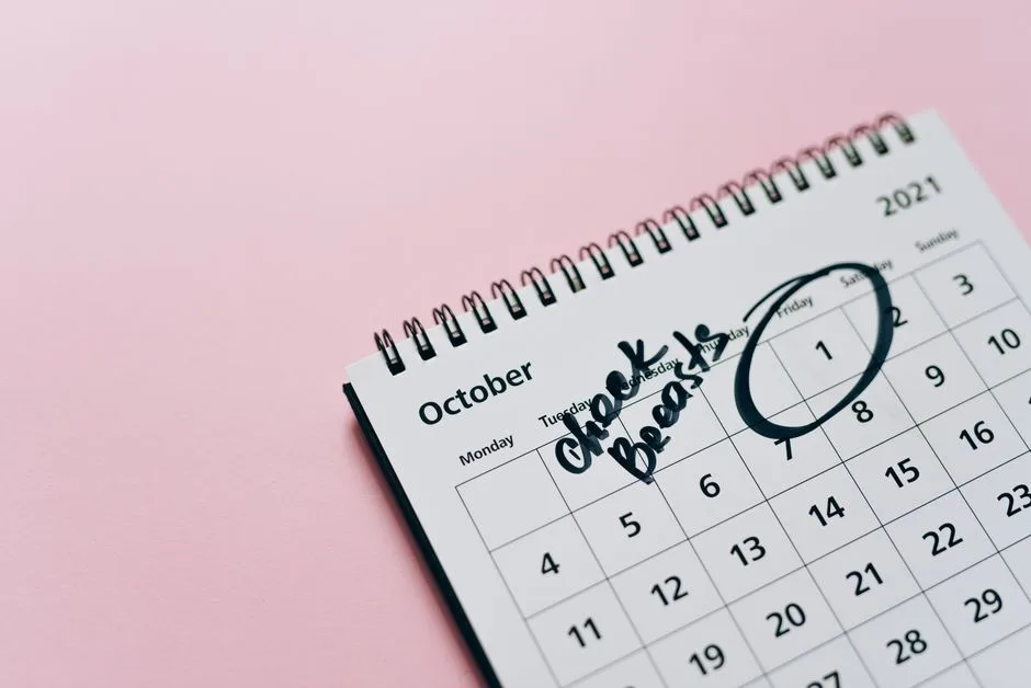 A calendar and tracker on a desk, building consistency one marked day at a time
