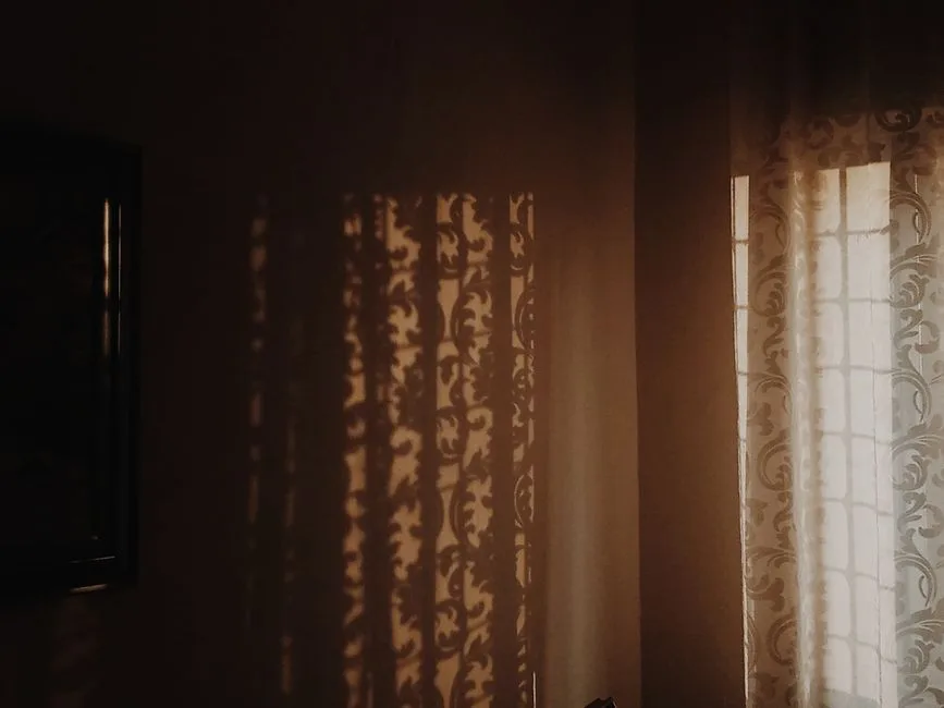 Gentle light reaching into a quiet, shadowed space — God's nearness to those who are hurting