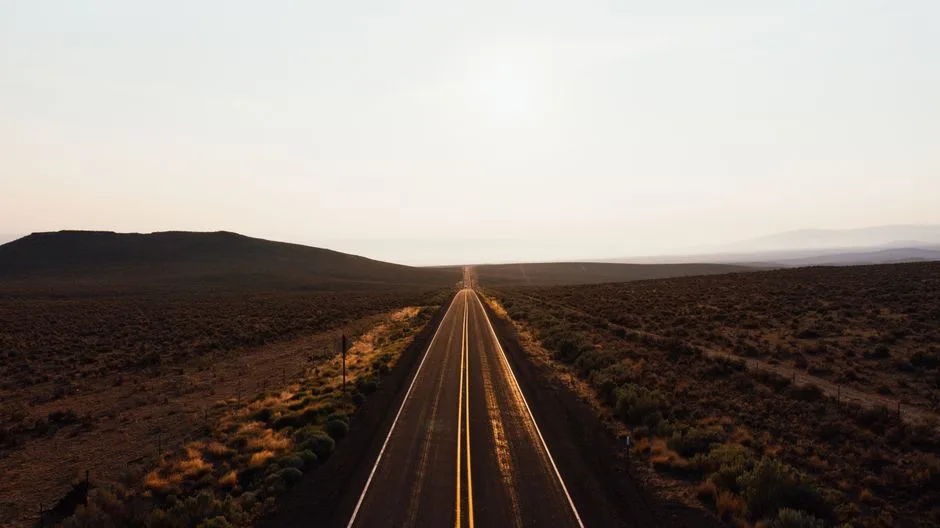 Sunrise over an open highway — a new start after a long, hard road