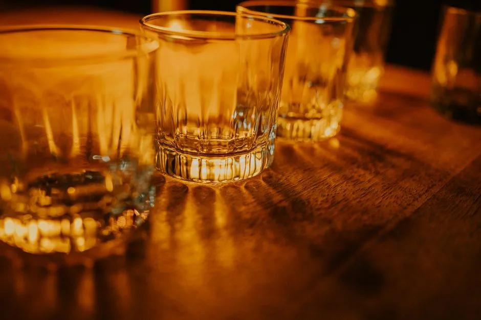 An empty glass and car keys on a table at night — the real, sobering consequences Proverbs describes