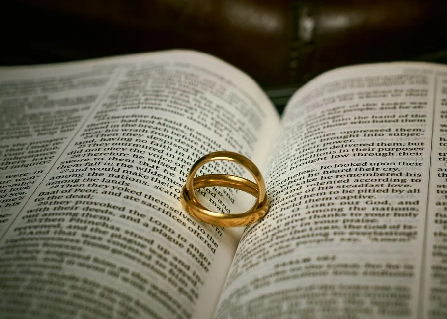 A wedding ring resting on an open Bible — the covenant boundary Scripture places around sexual intimacy
