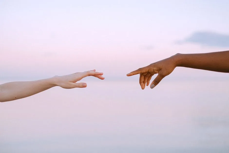 Two hands reaching toward each other — the priority of reconciliation before worship