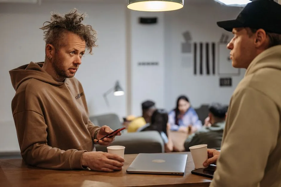 Two friends in honest conversation over coffee — the posture Scripture calls believers to with those who don't share their faith