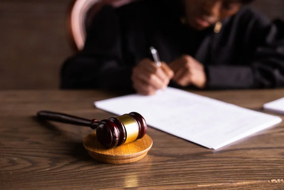 A judge's gavel resting beside an open Bible — earthly authority understood as accountable to a higher source