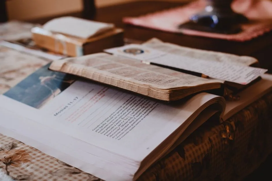 An open Bible beside a worn journal — the honest, emotionally real faith modeled by David
