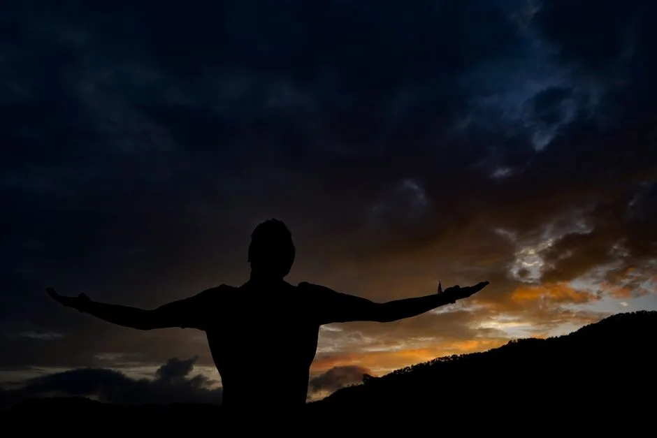 Open arms silhouetted against the sky — the welcome of a Father who never turns away
