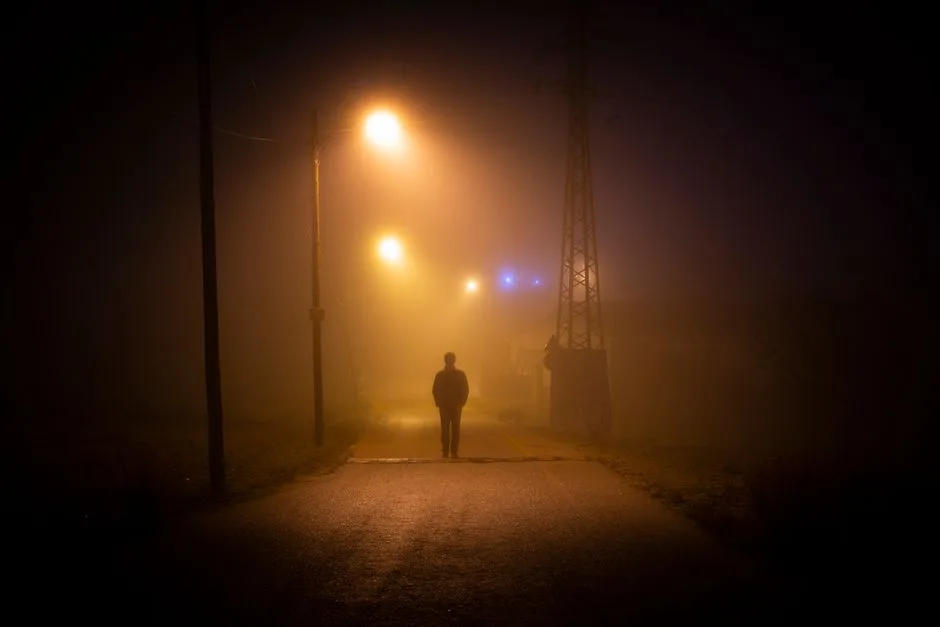 A single light cutting through fog on a dark road — God's presence as the answer to fear