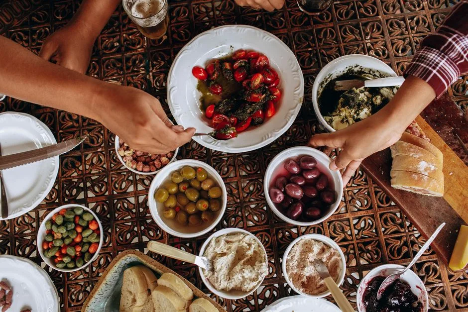 A simple shared meal at a wooden table — food received with gratitude rather than anxious rule-keeping