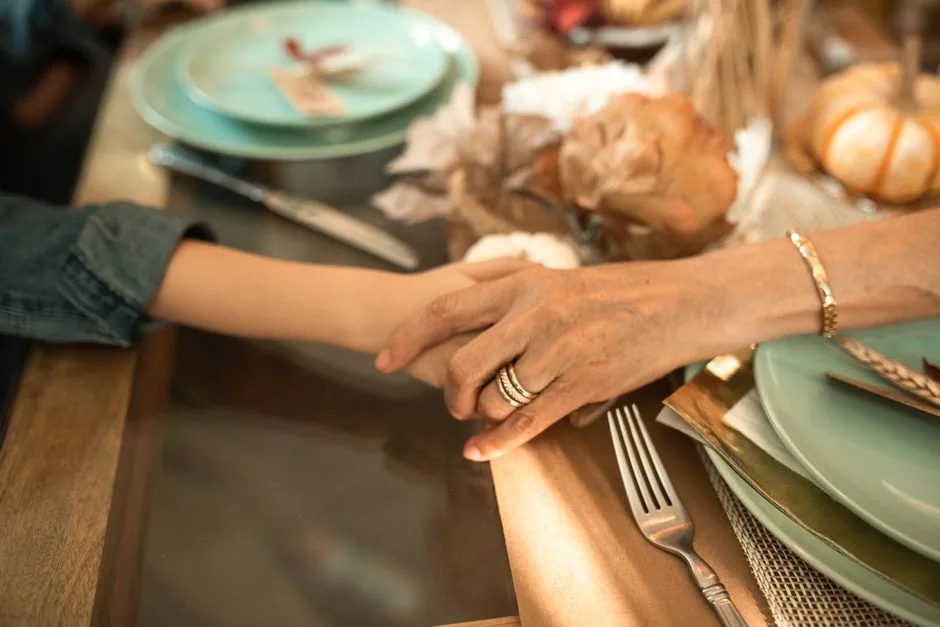 Hands giving thanks over a meal — gratitude as the consistent biblical posture toward food