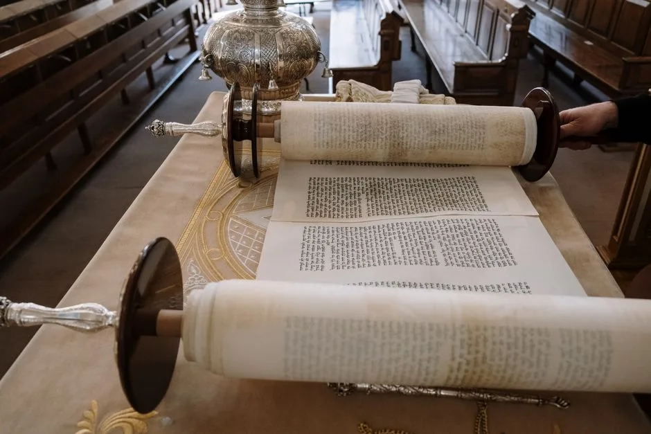An ancient scroll unrolled in soft light — the prophetic word recorded and preserved across centuries