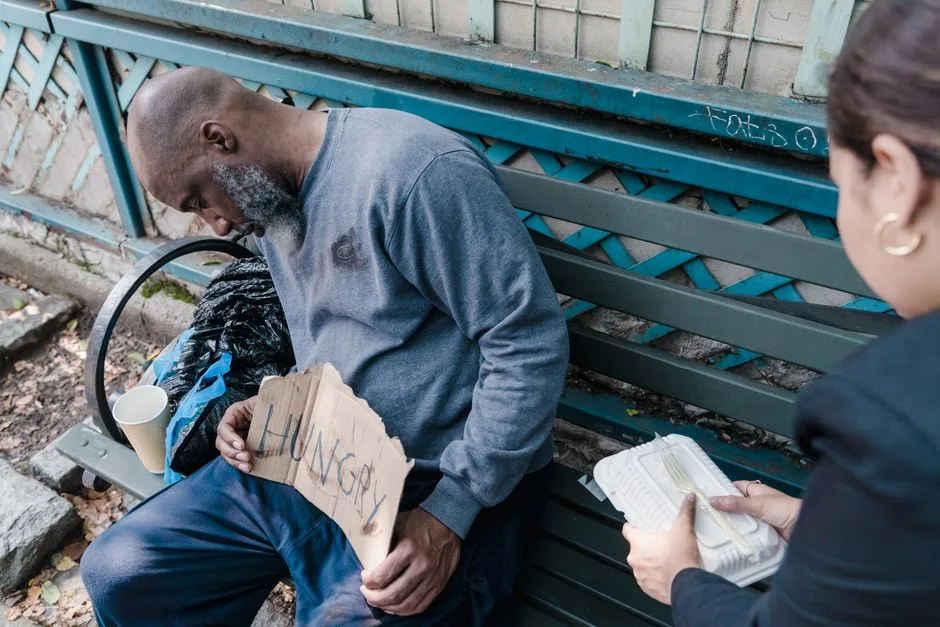 Hands offering food to someone in need — religion expressed through real, practical care
