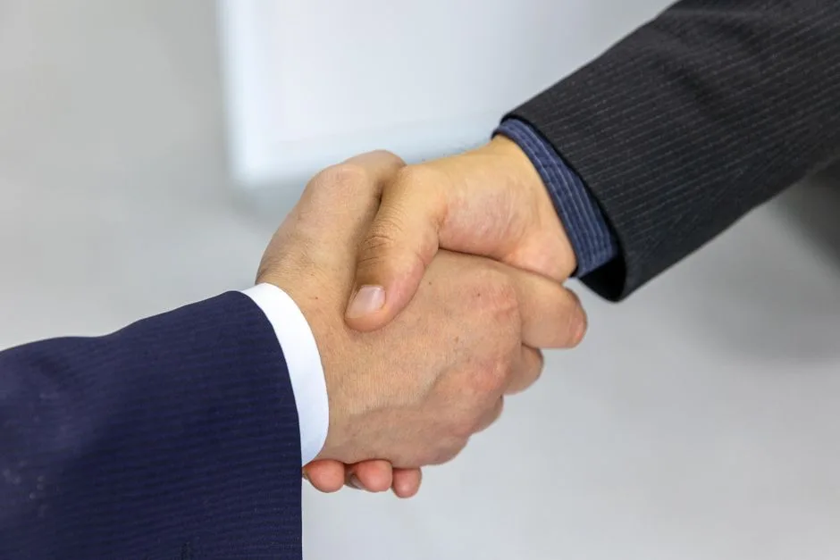 A handshake between two people — respect extended regardless of agreement or difference