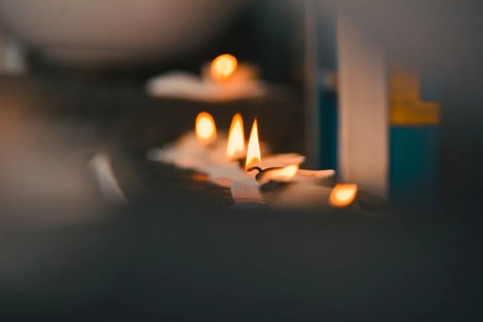 A candle burning steadily despite a draft — grace sustaining strength through ongoing weakness