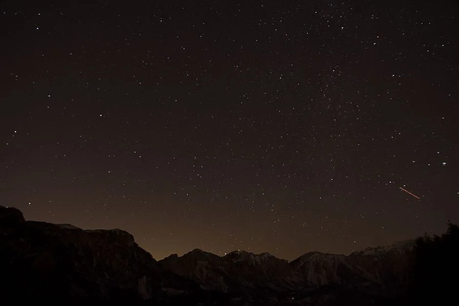 A vast night sky over mountains — the vastness of God revealed instead of a simple answer to suffering