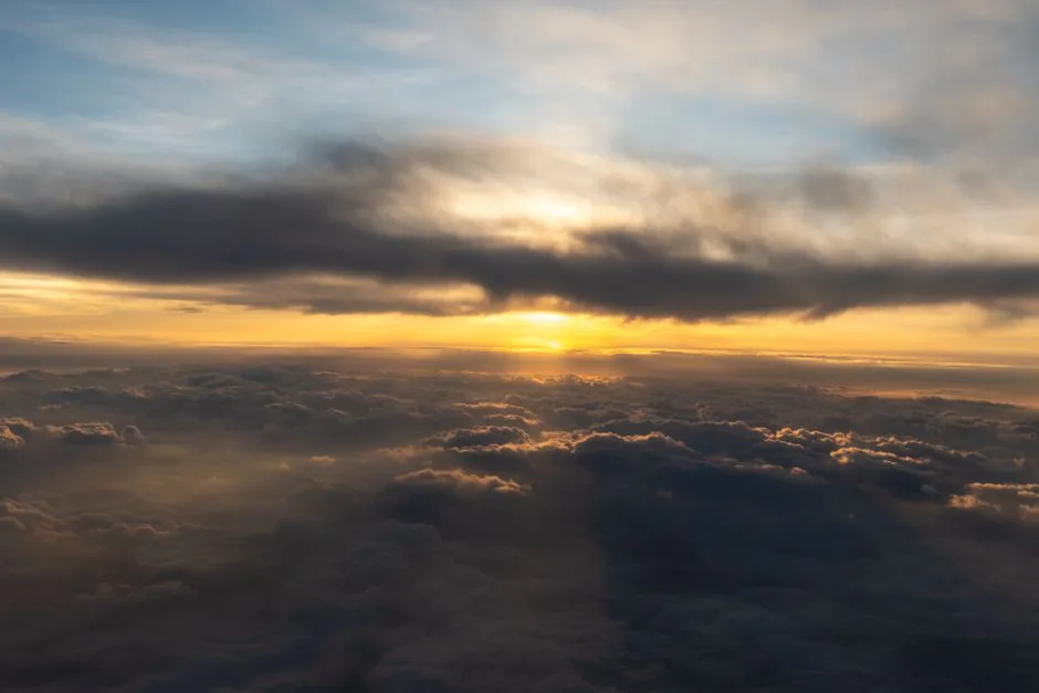Soft light breaking through clouds at dawn — the immediate hope Scripture describes for believers at death