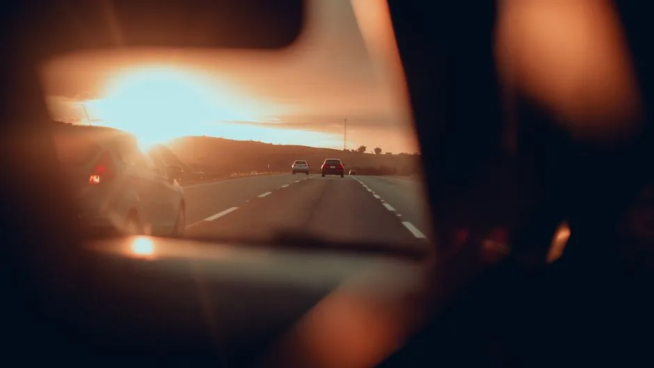 A quiet sunrise through a windshield — the promised presence of the Spirit on the long road