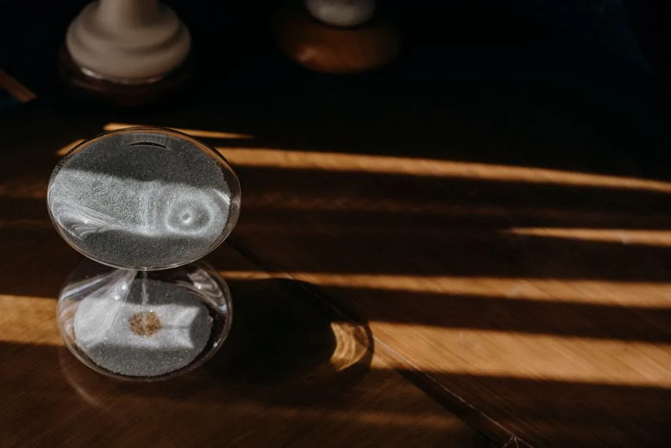 An hourglass on a wooden table — the quiet reminder that our days are numbered and meaningful