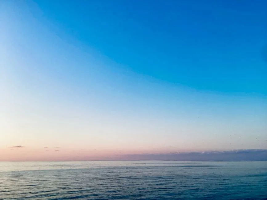 A calm sunrise breaking over open water — the peace that trust brings into a fearful moment