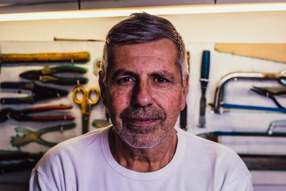 A retired man working on a woodworking project in his garage